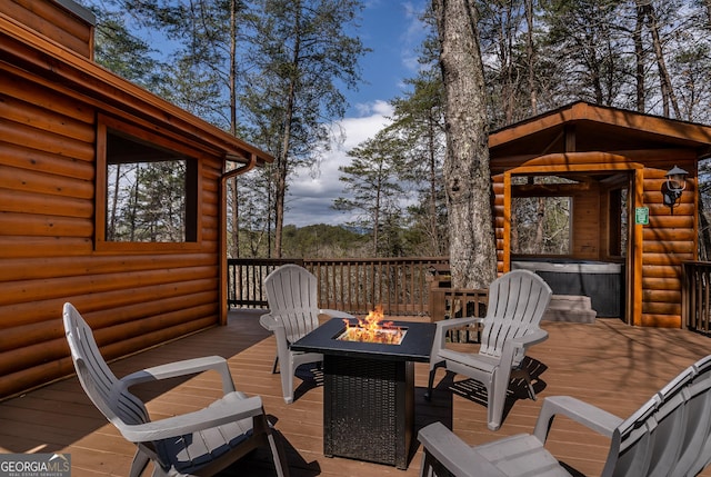 wooden terrace featuring a fire pit