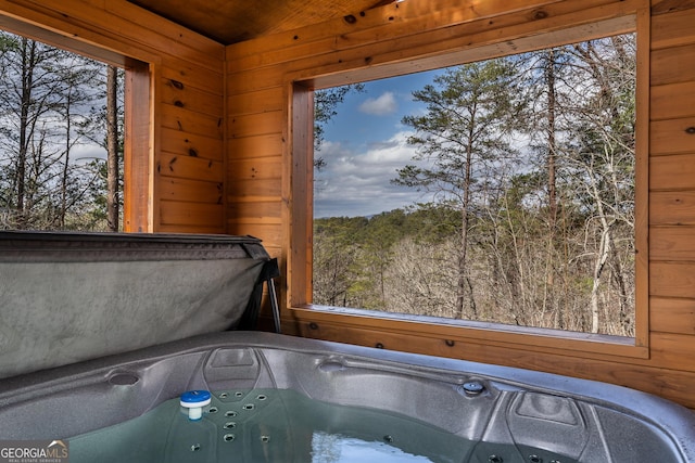 interior space with wooden walls and a hot tub