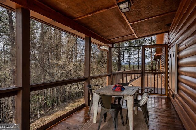 sunroom / solarium with outdoor dining space and a healthy amount of sunlight