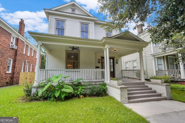 view of front facade with a front lawn and a porch