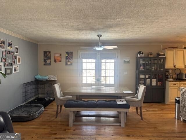 3209 Wax Rd SE, Aragon, GA 30104 - dining space with a ceiling fan, ornamental molding, light wood-style flooring, and a textured ceiling