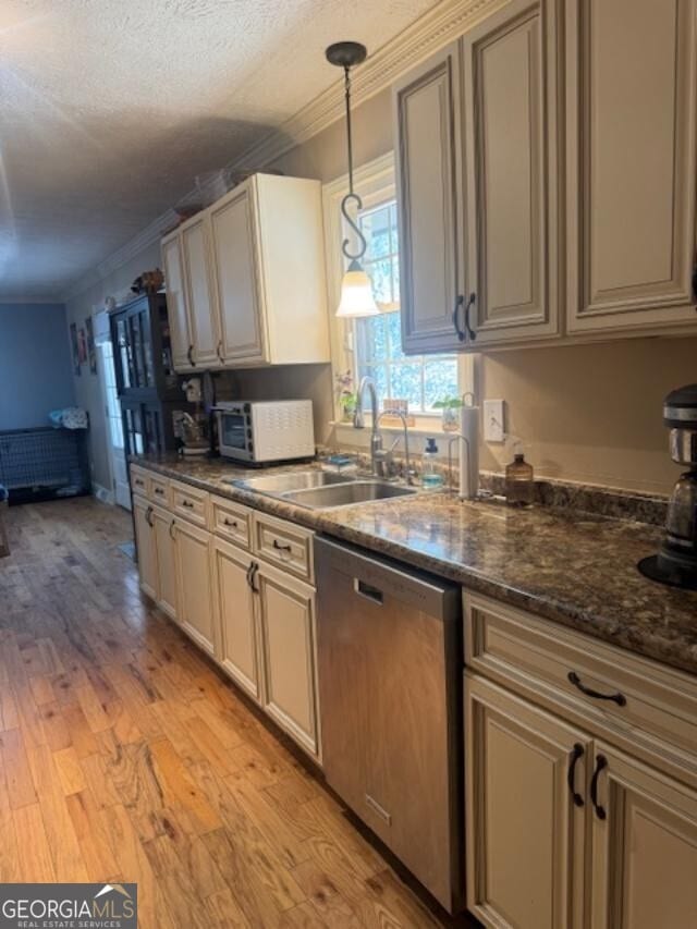 kitchen featuring dishwasher, light wood-style floors, and ornamental molding