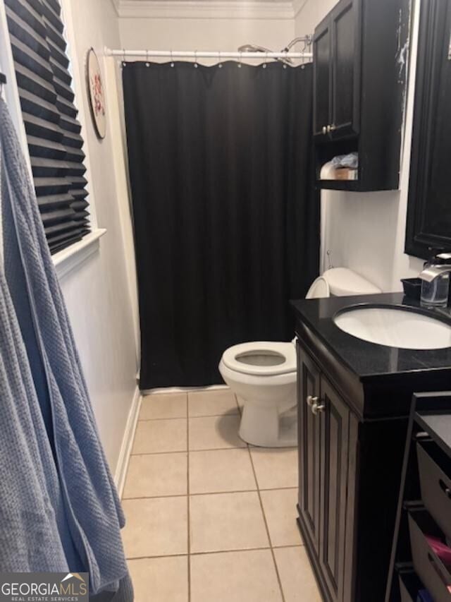 full bath with baseboards, toilet, ornamental molding, tile patterned floors, and vanity