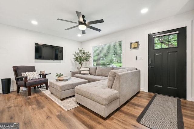 living room featuring recessed lighting, baseboards, wood finished floors, and a ceiling fan