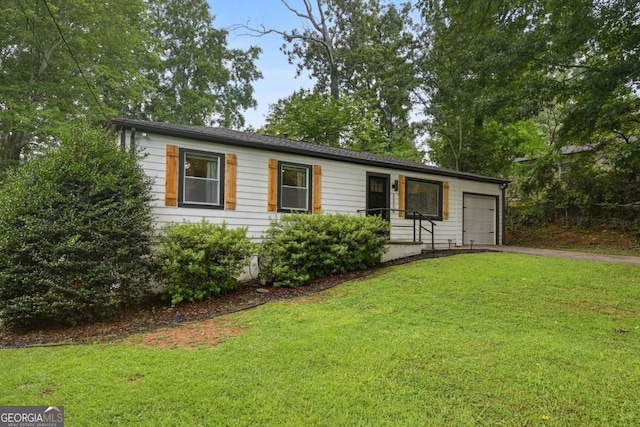 single story home featuring a front yard, a garage, and driveway