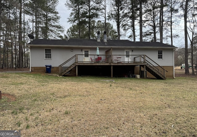 rear view of house with stairs, a deck, and a lawn