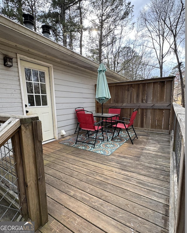 wooden deck featuring outdoor dining area