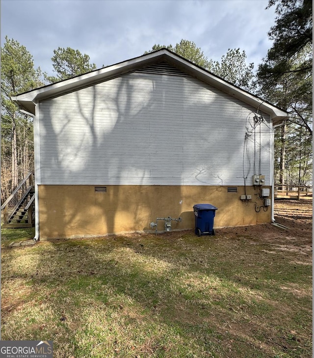 view of home's exterior featuring crawl space and a lawn