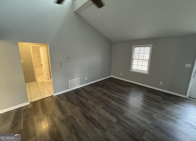 bonus room featuring lofted ceiling, baseboards, visible vents, and dark wood finished floors