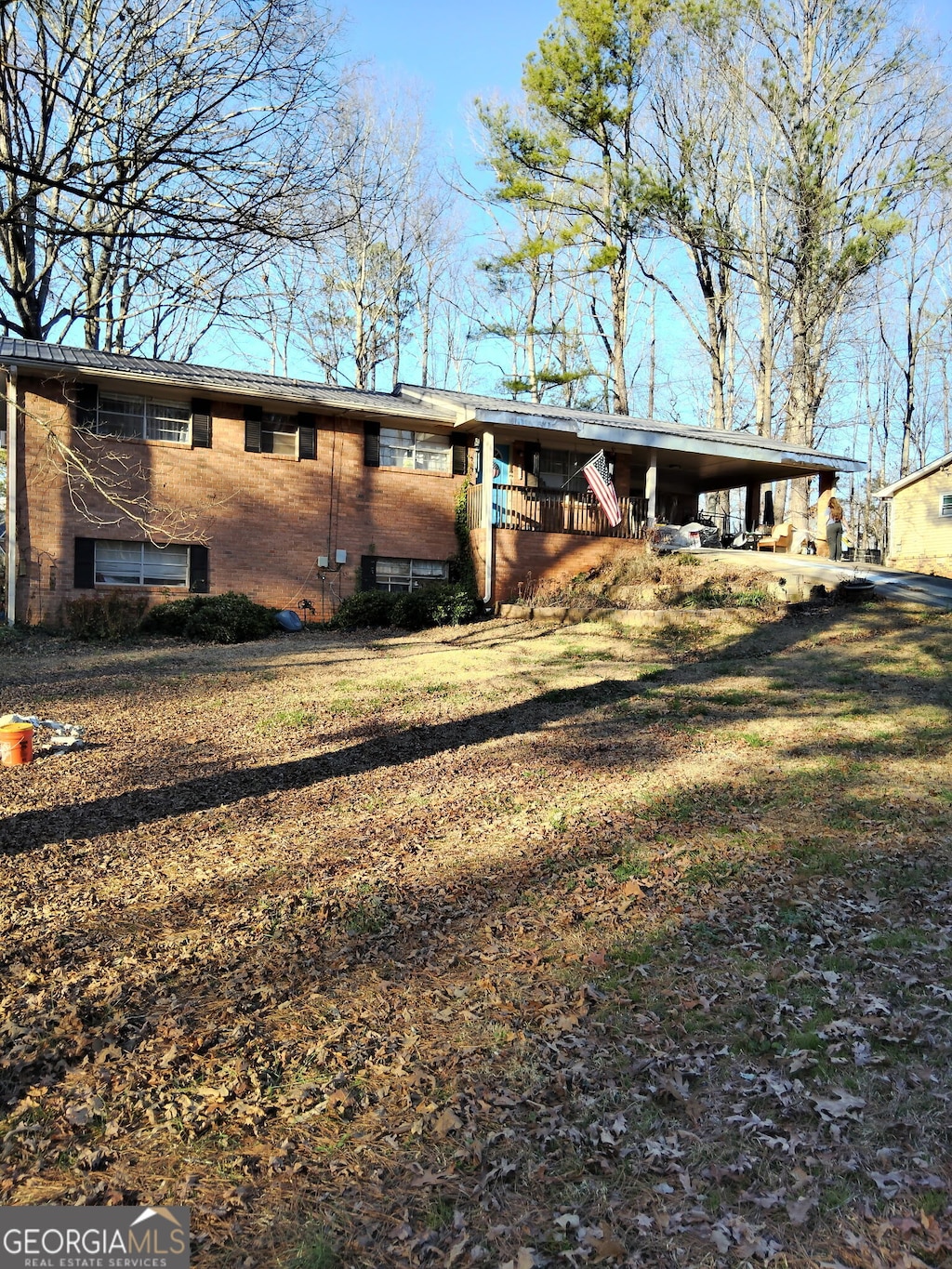 exterior space with an attached carport and brick siding