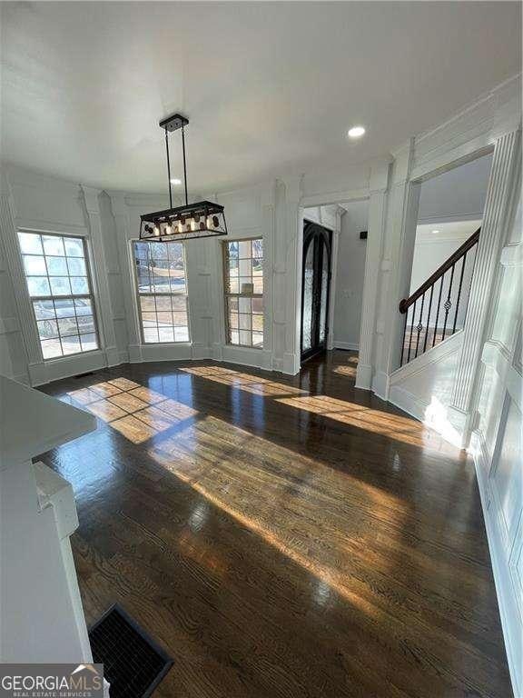 unfurnished dining area with stairway, wood finished floors, visible vents, and recessed lighting