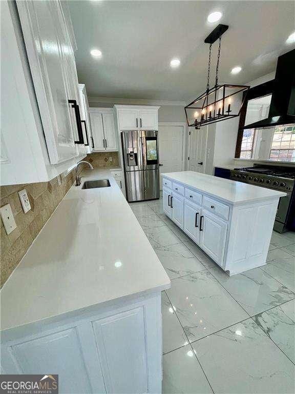 kitchen featuring white cabinets, a kitchen island, appliances with stainless steel finishes, marble finish floor, and a sink