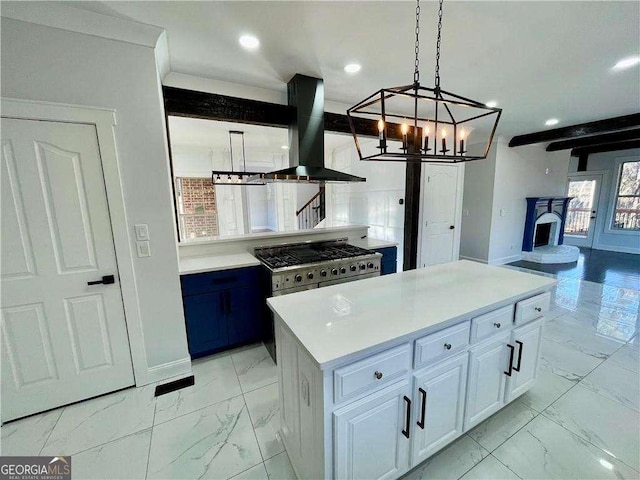 kitchen featuring marble finish floor, light countertops, island range hood, and white cabinetry