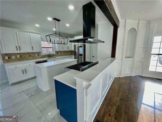 3499 Lake Mill Rd, Buford, GA 30519 - kitchen featuring wall chimney exhaust hood, light countertops, plenty of natural light, white cabinets, and ornamental molding