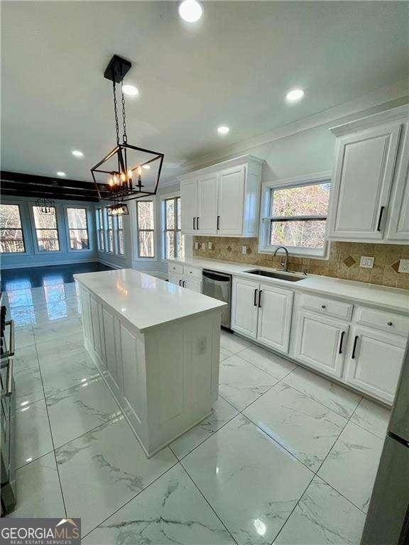 3499 Lake Mill Rd, Buford, GA 30519 - kitchen featuring a sink, light marble finish floors, stainless steel dishwasher, white cabinetry, and a center island