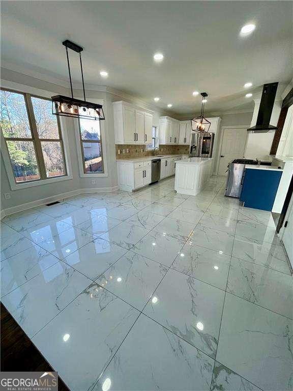 interior space featuring exhaust hood, baseboards, white cabinets, marble finish floor, and dishwasher