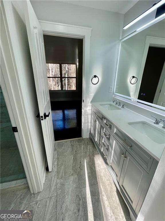 bathroom with a sink and double vanity