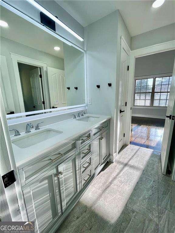 bathroom with double vanity and a sink