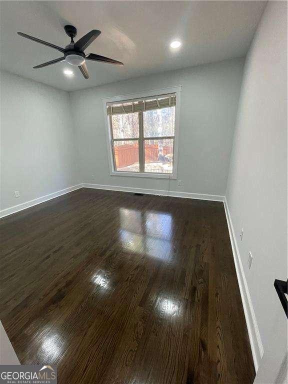 unfurnished room featuring recessed lighting, dark wood-style flooring, ceiling fan, and baseboards