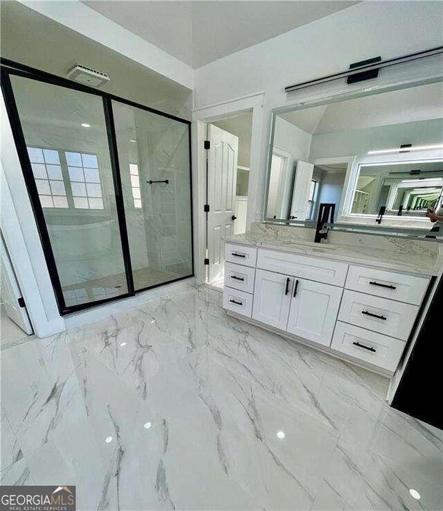 full bathroom with a stall shower, marble finish floor, and vanity