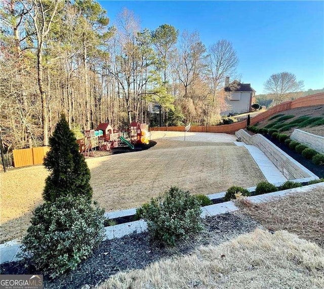 view of yard with fence and a playground