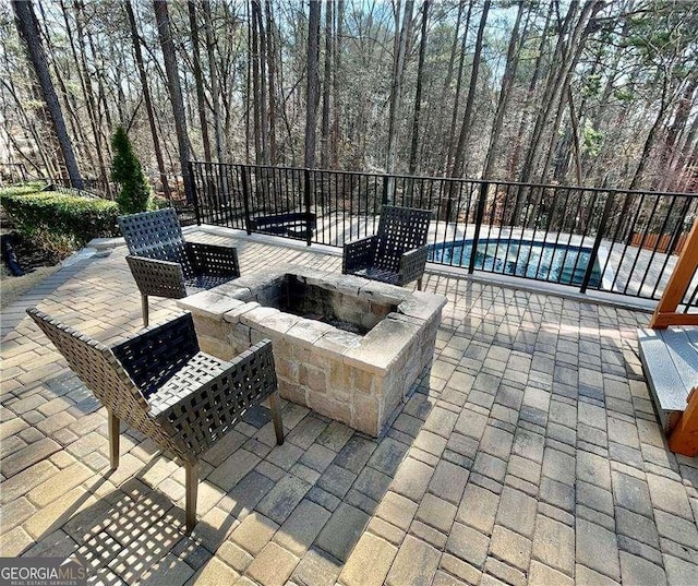 view of patio / terrace with a fire pit and a pool