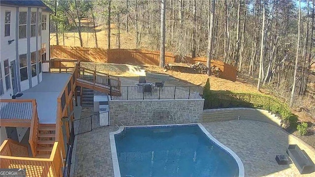 view of pool featuring a patio, stairway, fence, and a fenced in pool