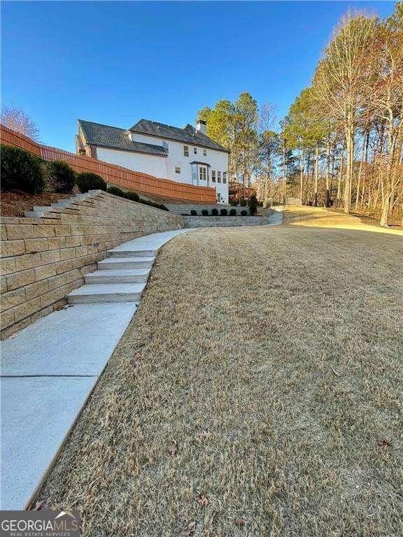 view of side of property with a lawn