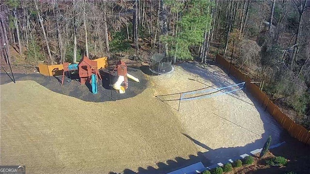 view of play area featuring a wooded view