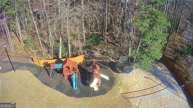 birds eye view of property featuring a view of trees