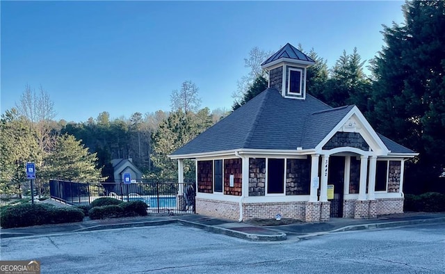 view of front of property with fence and brick siding