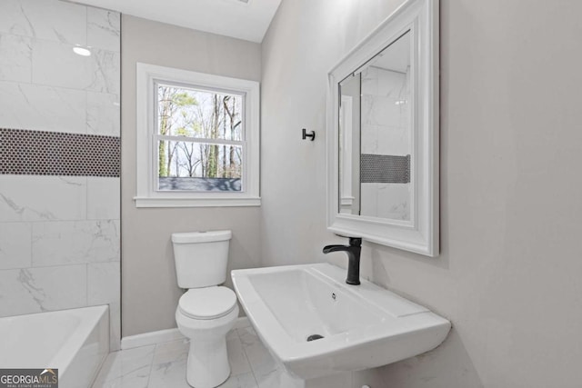 full bathroom featuring marble finish floor, a sink, toilet, and baseboards