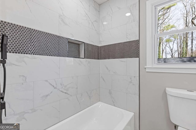 bathroom with shower / washtub combination and toilet