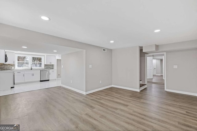 5277 Cardinal Ln NW, Lilburn, GA 30047 - unfurnished living room featuring recessed lighting and light wood-style floors