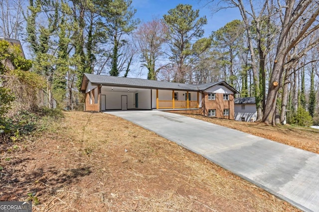 5277 Cardinal Ln NW, Lilburn, GA 30047 - ranch-style home with concrete driveway and an attached carport