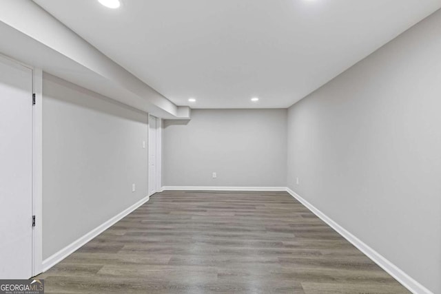 finished basement with recessed lighting, baseboards, and wood finished floors