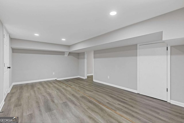 finished basement with baseboards, wood finished floors, and recessed lighting