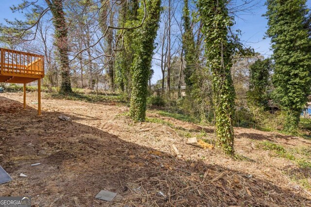 5277 Cardinal Ln NW, Lilburn, GA 30047 - view of yard with a wooden deck