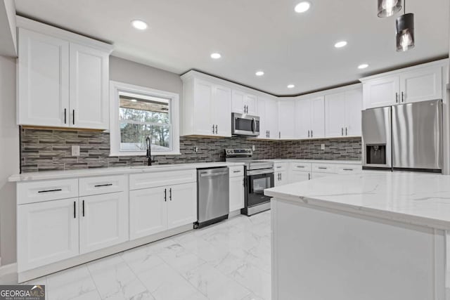 5277 Cardinal Ln NW, Lilburn, GA 30047 - kitchen with stainless steel appliances, light marble finish flooring, recessed lighting, white cabinetry, and light stone countertops