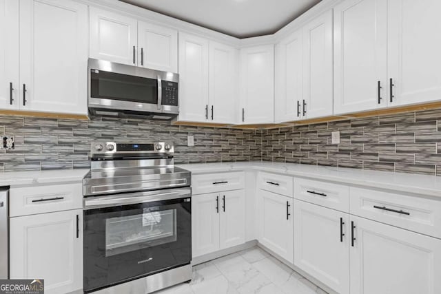 5277 Cardinal Ln NW, Lilburn, GA 30047 - kitchen featuring appliances with stainless steel finishes, light marble finish floors, white cabinets, backsplash, and light stone counters