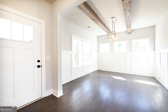 entrance foyer with beam ceiling, plenty of natural light, visible vents, and dark wood-style flooring