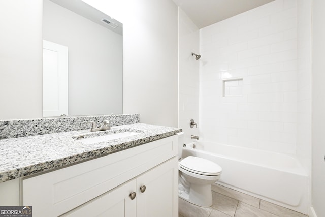 full bath featuring tile patterned floors, toilet, vanity, and  shower combination