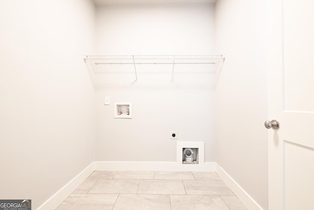 laundry room with electric dryer hookup, washer hookup, baseboards, and light marble finish flooring