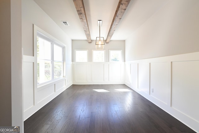unfurnished dining area with a decorative wall, beamed ceiling, plenty of natural light, dark wood finished floors, and wainscoting
