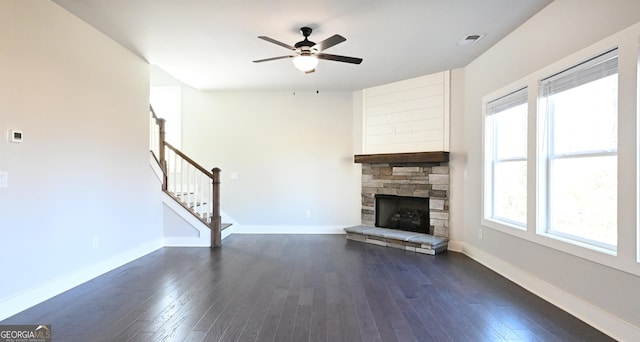 unfurnished living room featuring stairway, baseboards, and dark wood-type flooring