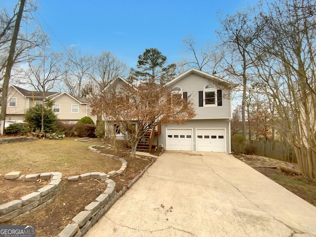 view of front facade with concrete driveway, stairway, and an attached garage