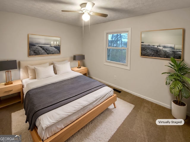 carpeted bedroom with visible vents, ceiling fan, a textured ceiling, and baseboards