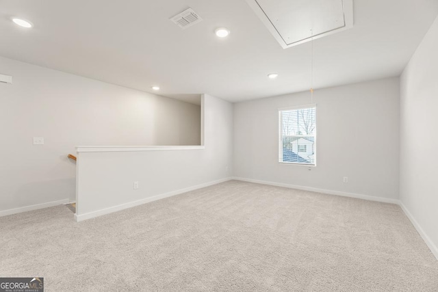 spare room with carpet, attic access, visible vents, and recessed lighting