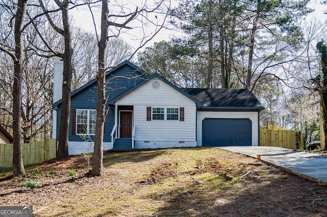 view of front of home featuring a chimney, crawl space, fence, a garage, and driveway