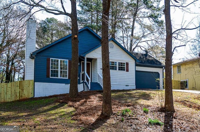 view of front of house with crawl space, a chimney, a garage, and fence